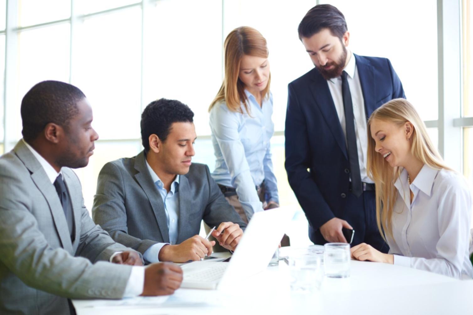 Professional business planning consultation showing strategic documents and market analysis